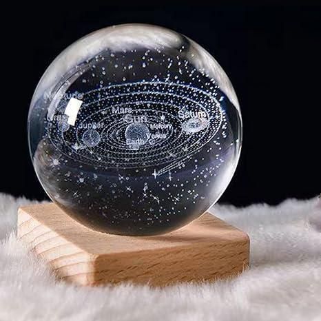 Glowing 3D crystal ball on a wooden stand with intricate internal designs.